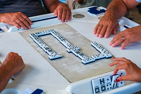 An up close stock photo of a game of dominos on Calle Ocho in Miami, Florida.