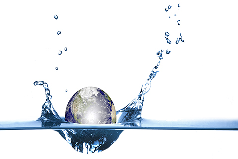 An image of a globe being dropped into water.