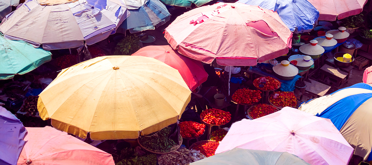 A overhead photo of umbrellas in a market.