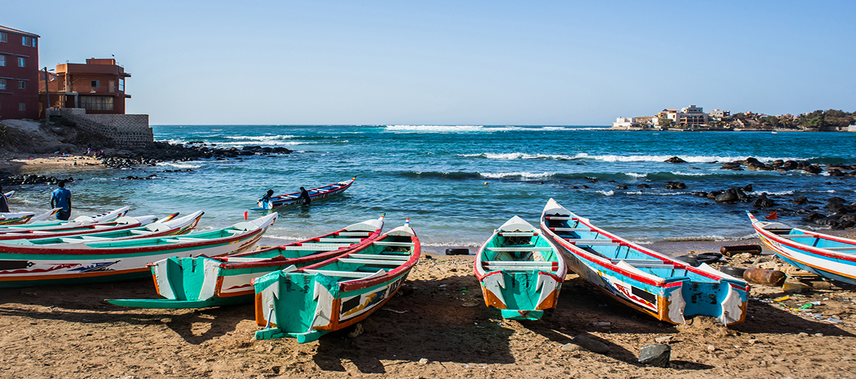 A stock photo of fishing boats in Ngor, Dakar, Senegal.